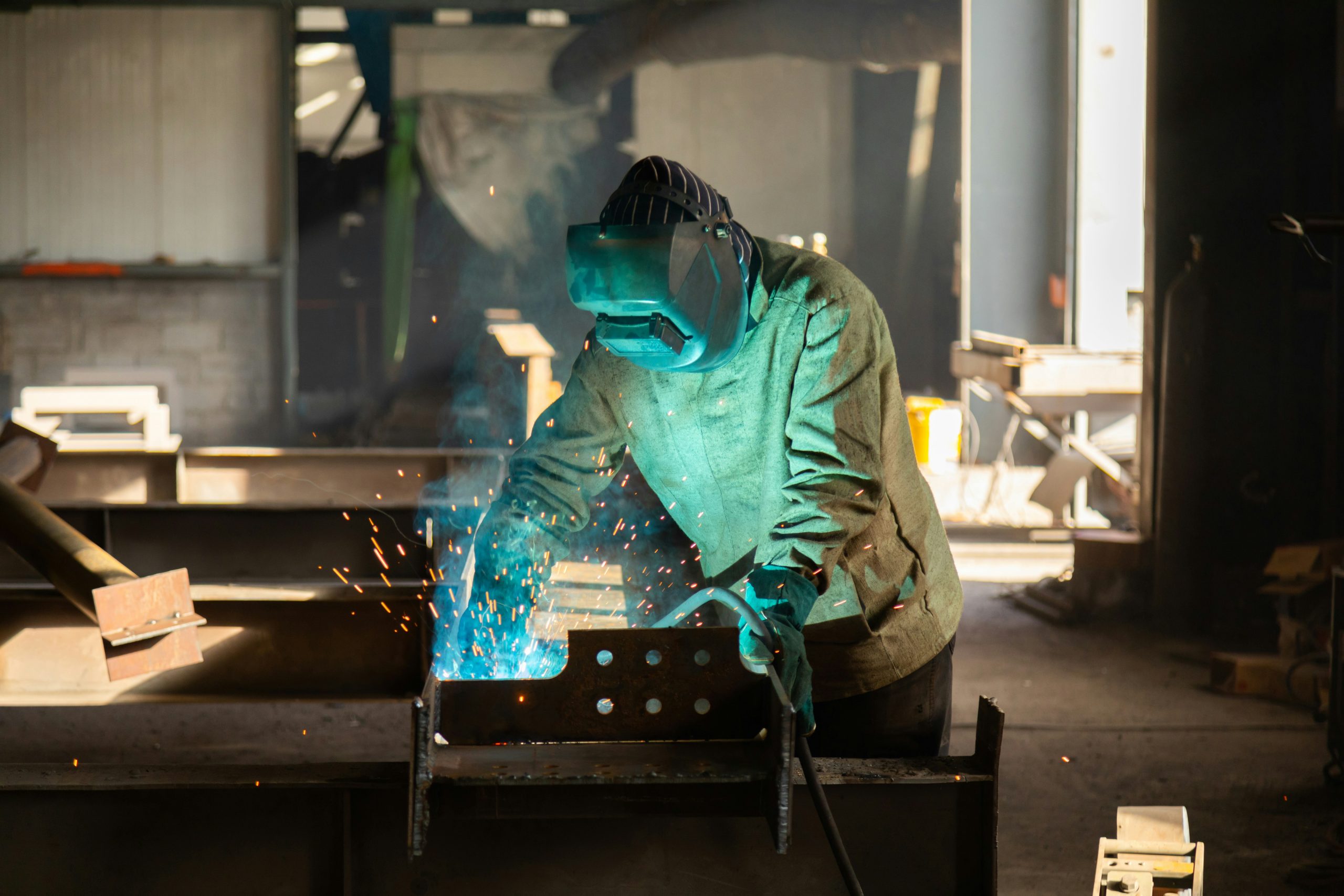Metal fabrication worker cutting and shaping steel in a fabrication workshop