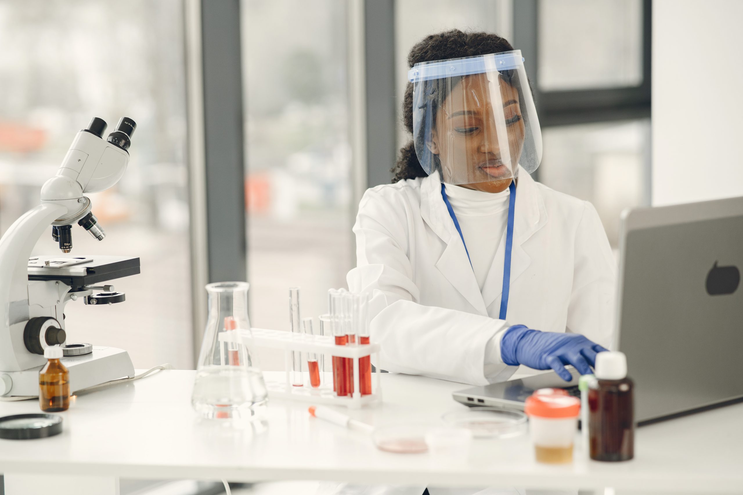 Researcher inspecting samples in a chemical laboratory